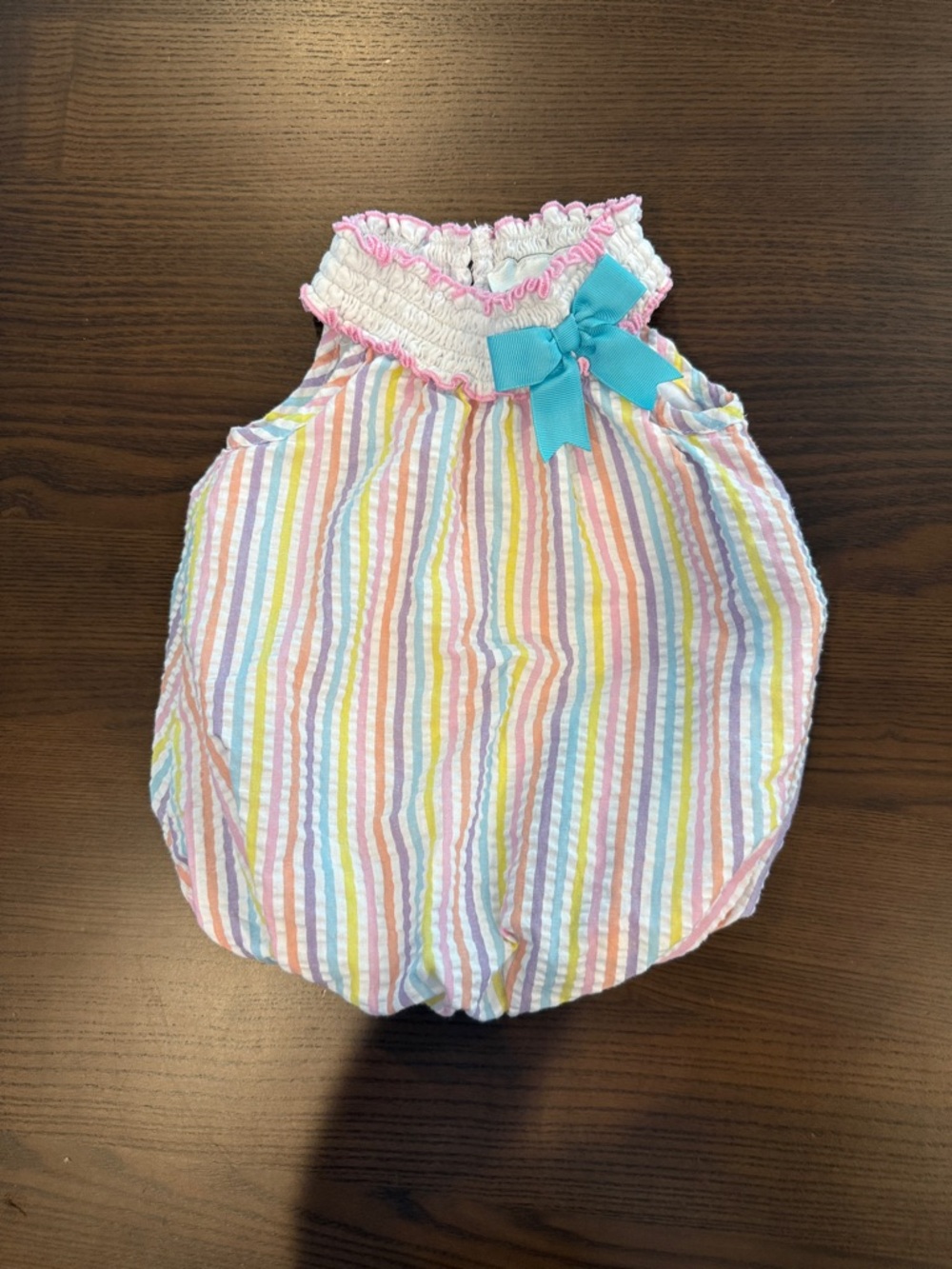 Rare Editions Pastel Multi-Stripe Seersucker Bubble Romper with Blue Bow.